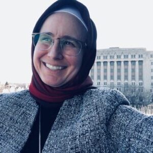 Atty. Janaan Hashim smiling in front of the Cook County Criminal Courthouse